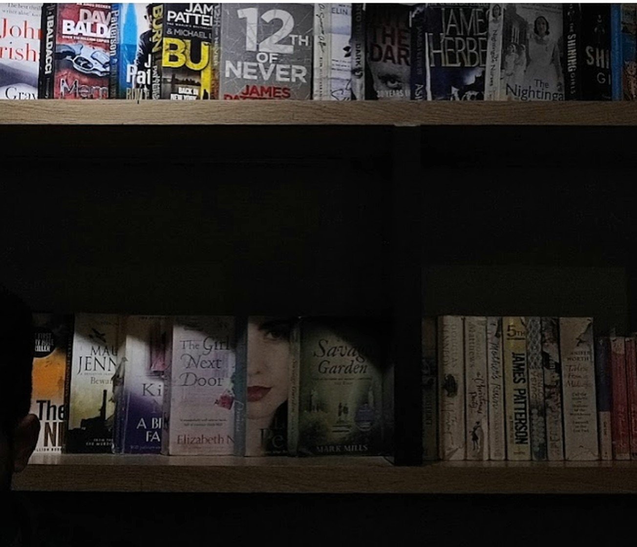 Shelves of paperback novels in the library corner at Second Cup Johar Town