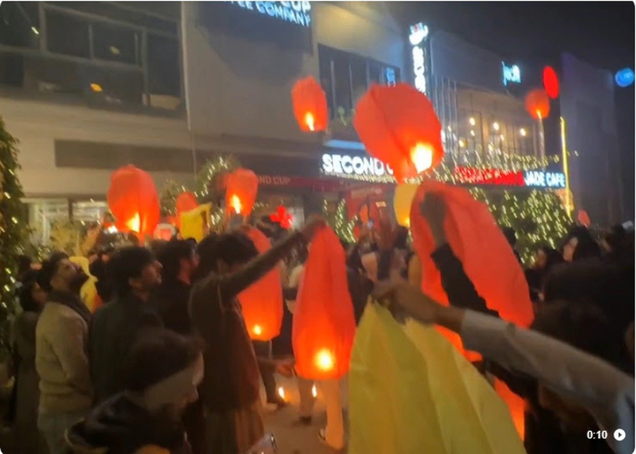 Sky lanterns released outside Second Cup Johar Town at night