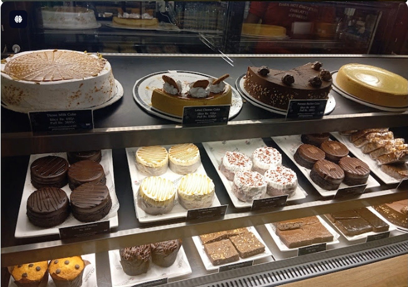 Cake and pastry display case at Second Cup Johar Town